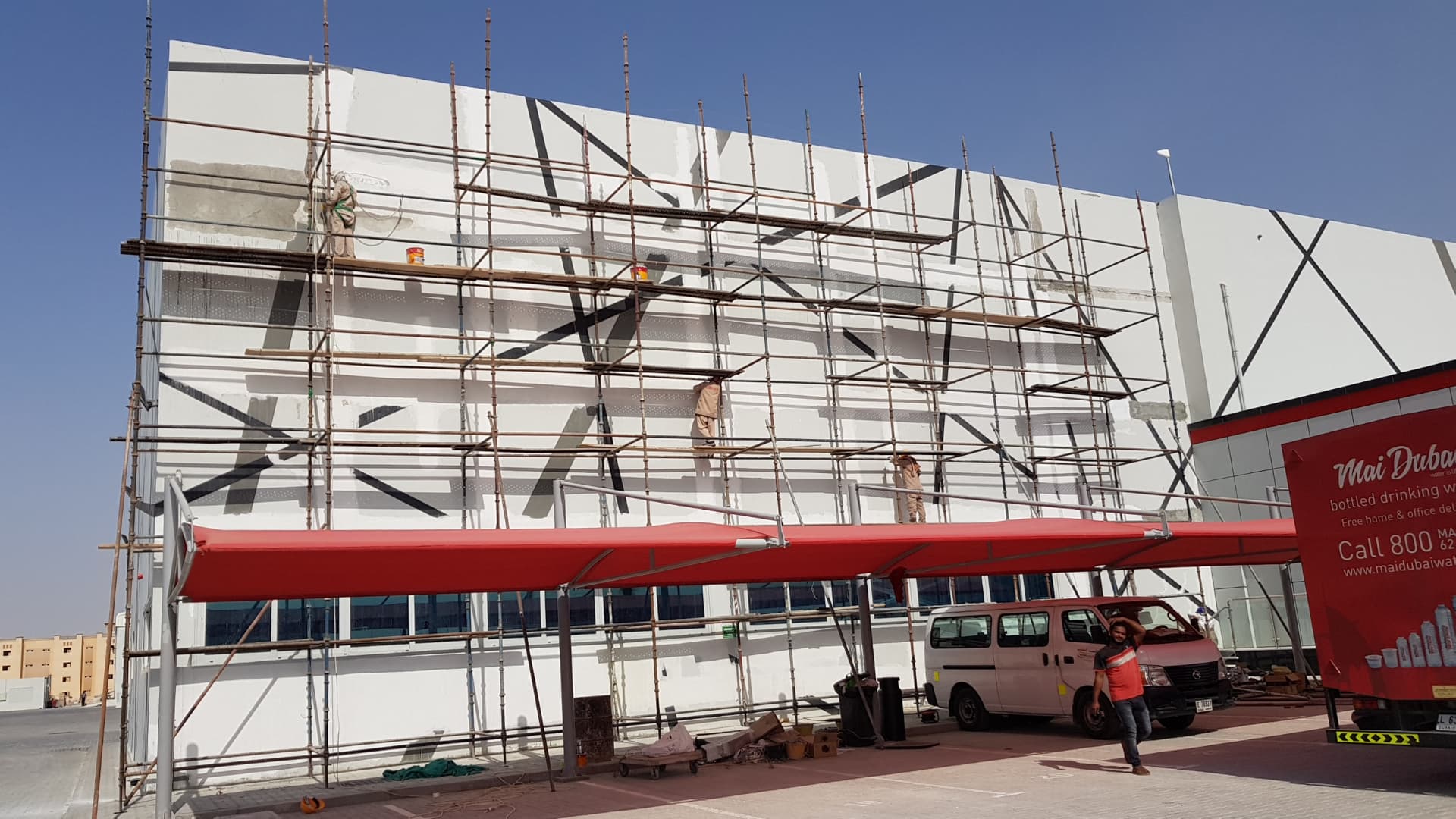 Facade finishing works on scaffolding